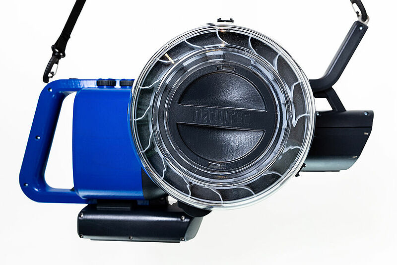 Front View of the Airobreez. From left to right, the grip handle, the motor body, the product hopper and the long distance nozzle. Rising above is the nozzle grip and comfort strap. Below the motor body is the battery pack housing.